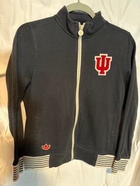 Adidas women’s navy blue jacket with Indiana University (IU) embroidered logo.
